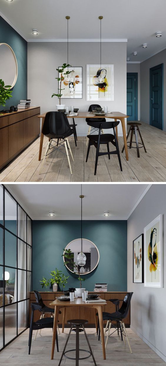 In this small apartment, the dining area has a deep teal blue accent wall that ties in with the front door and storage closet, while the wood furniture adds a natural touch and the black chairs match the black framed glass wall of the bedroom.