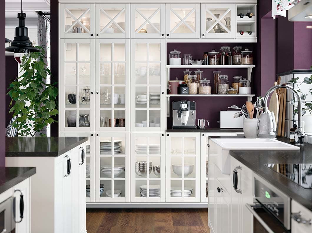 A white kitchen with glass doors