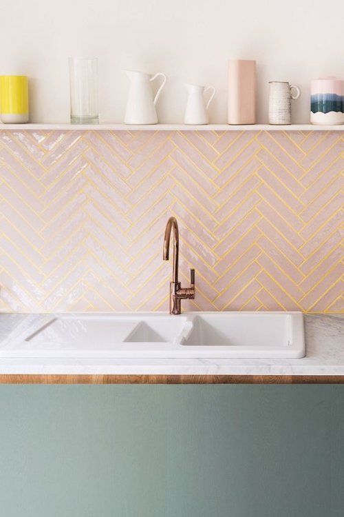 kitchen backsplash with pink tile with yellow grout; floating shelf above