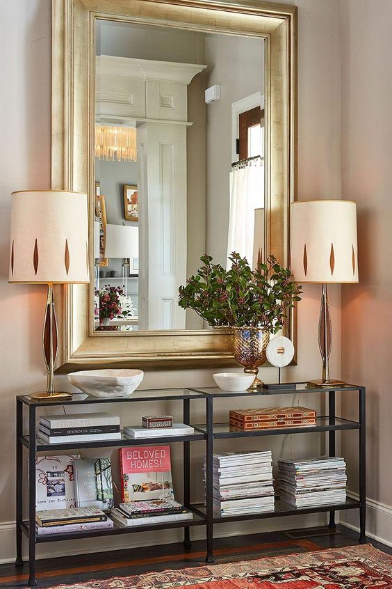 Stylist Natalie Nassar's Atlanta home has a narrow entry that she's outfitted with a narrow entry console and an oversized mirror #interiordesignmagazine