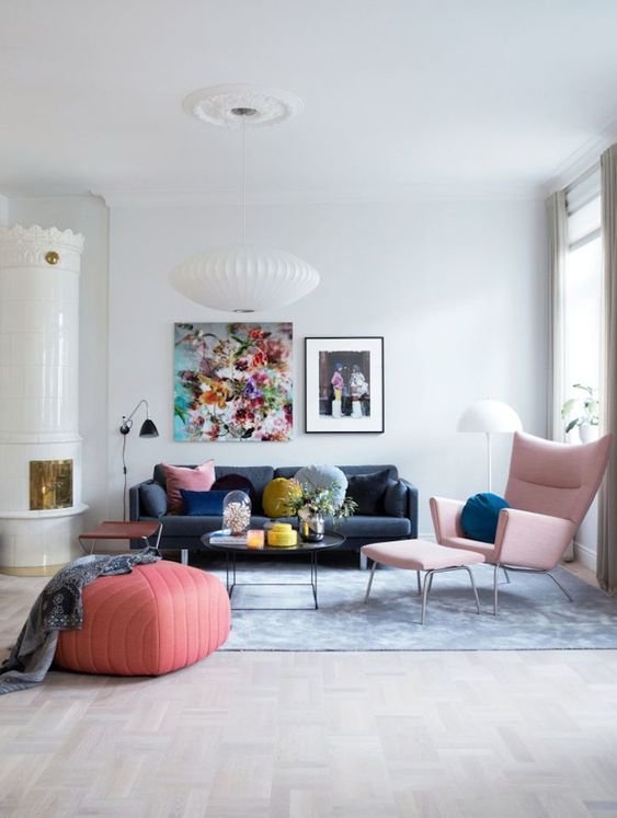 Lessons To Learn From A Colourful Yet Calm Norwegian Home - sitting room with pink armchair and pouf