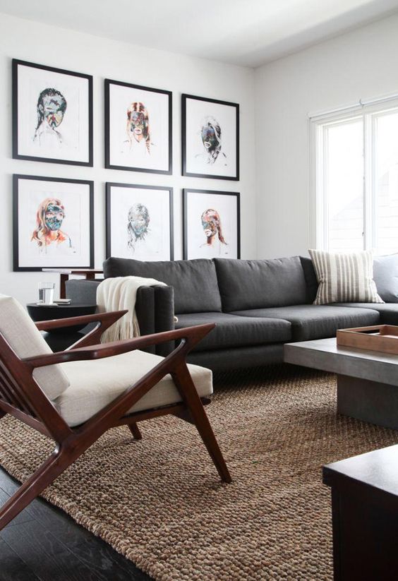 Nice living room design with framed gallery wall, grey sofa and mid-century armchair
