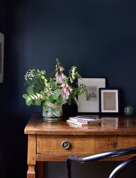 Soft florals look gorgeous against a dark wall.