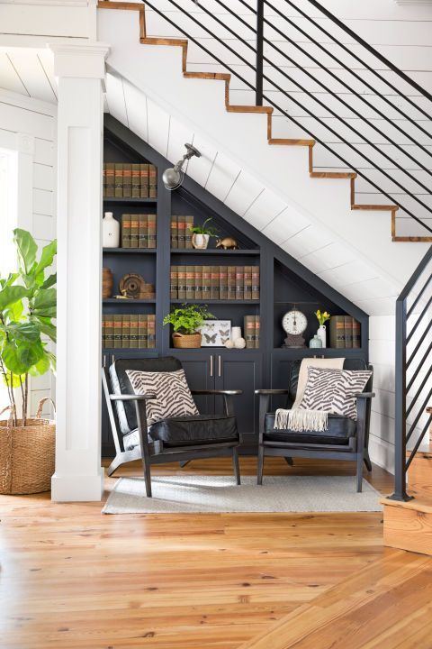 "The area under the stairs is often wasted space," says Joanna. "We transformed this spotâ once a closet with book storage on one sideâinto a library nook, which feels perfect for a B&B. I always say 'Look beyond what's already there and make your home work for you.' "