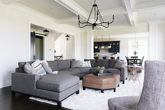 This living room is about 30x17' with 10' ceilings To bring detail and coziness to the large space the designer designed a coffered ceiling and a fireplace mantel that drew your eye up to the ceiling detail
