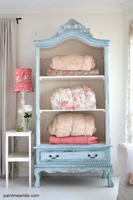 Find an old wardrobe, take off doors, paint with milk paint, and display extra blankets, quilts, sheets and towels in guest room.