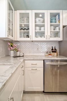 I do like the haringbone backsplash and overall colors here. This kitchen would be too white for Martial