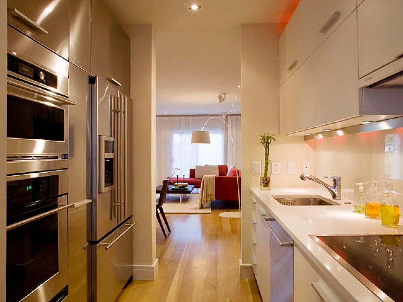 galley-kitchen-design-with-white-glossy-cabinet-on-cream-laminate-wood-floor.jpeg