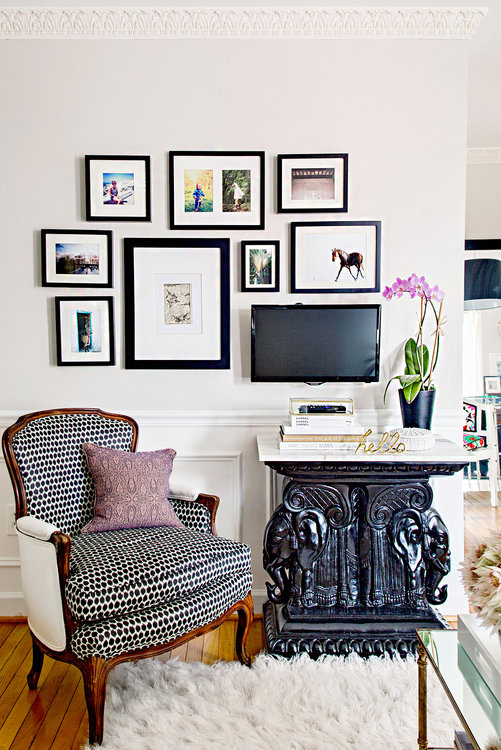 Sitting area with tv and framed artwork on wall